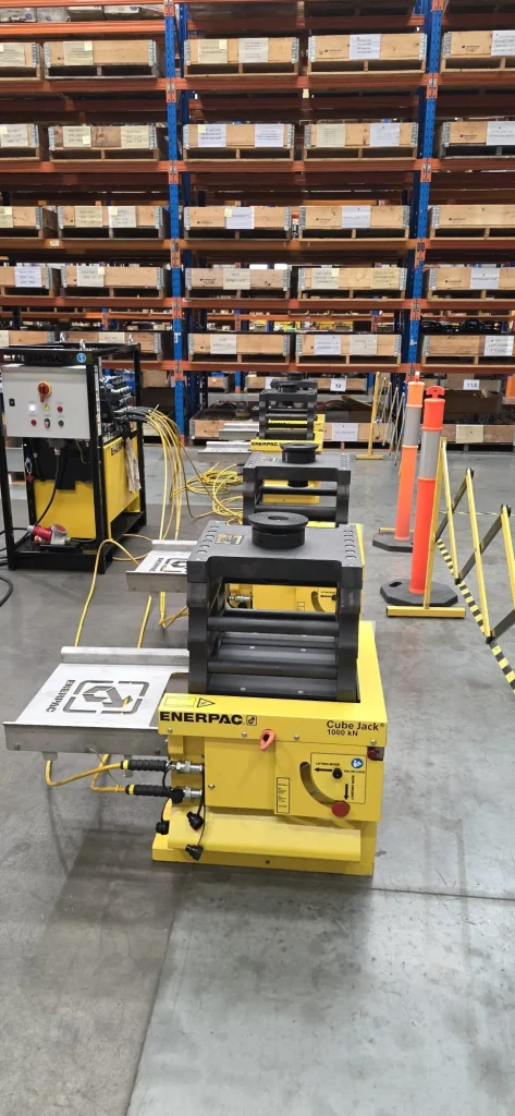 Enerpac Cube Jack hydraulic jacking units staged in an ALS International warehouse