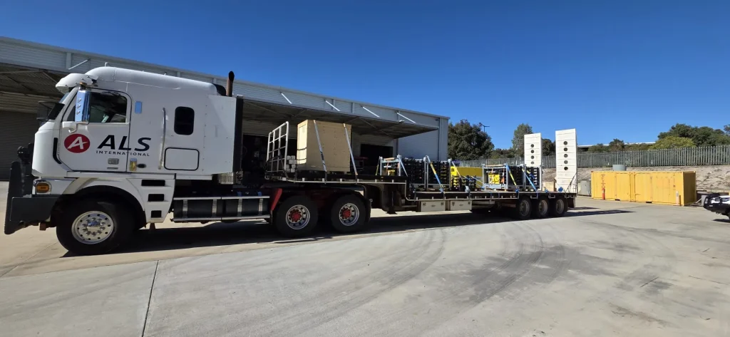 ALS International truck loaded with a timber project-cargo crate and steel stillages