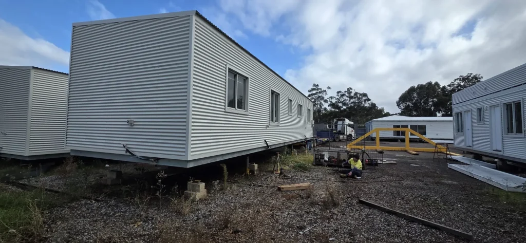 Relocatable site building set down on stands during installation by ALS International