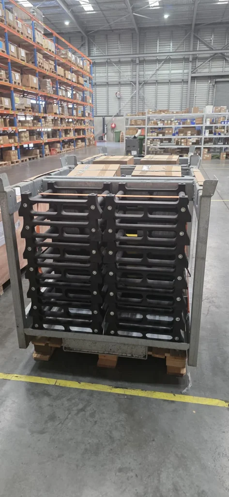Steel stillage storage racks stacked on a pallet in an ALS International warehouse