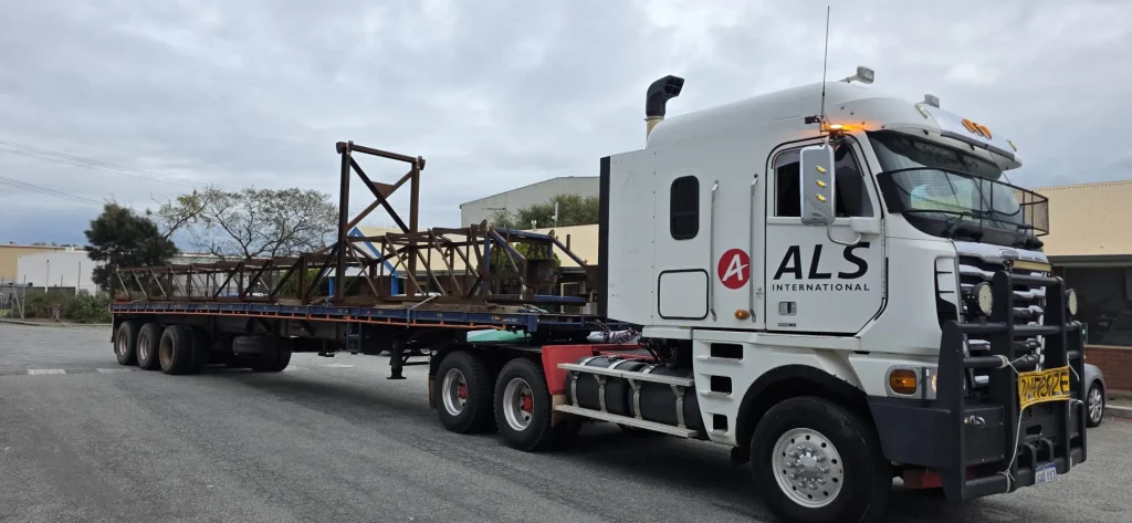 ALS International flatbed truck transporting a fabricated structural steel assembly
