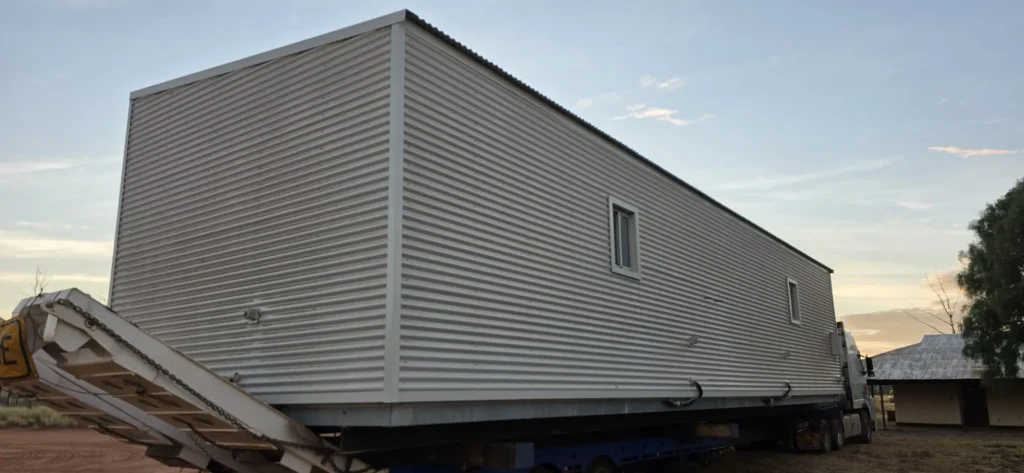 Oversize transportable building module on an ALS International float in the outback
